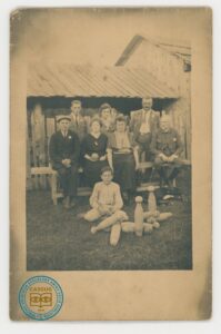 Grupa osób siedząca na ławkach